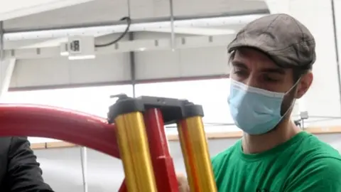 Reuters Worker at electric motorcycle plant