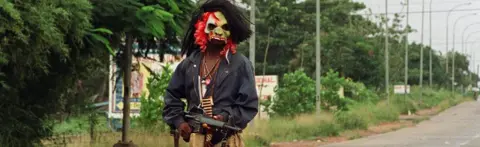 AFP A masked fighter in Liberia's civil war