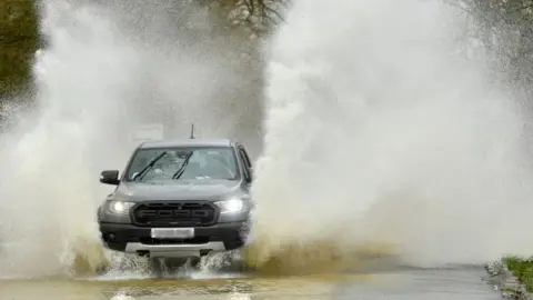 PA Media Vehicle navigates flooded road in Leicestershire