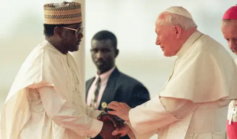 JEAN-PHILIPPE KSIAZEK/AFP/GETTY Images Sani Abacha meets with former Pope John Paul II