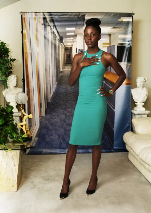 Endia Beal / Catherine Edelman Gallery Portrait by Endia Beal showing a woman dressed for the corporate workplace