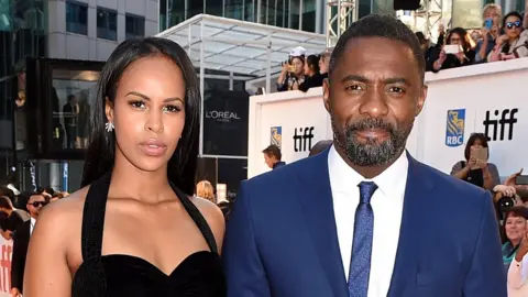 Getty Images Sabrina Dhowrie and Idris Elba