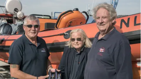 RNLI A photo of the couple and Coxswain Jonathon Blakeston