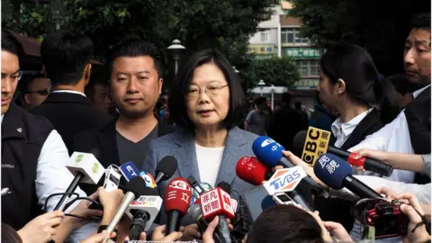 EPA President Tsai Ing-wen speaks to reporters after casting her vote