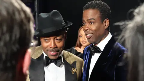 Getty Images Will Packer (left) with Chris Rock backstage during the Oscars