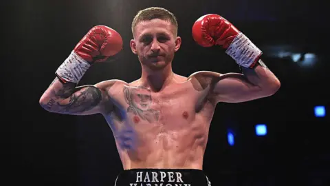 Ryan Garner poses for a photo after winning 