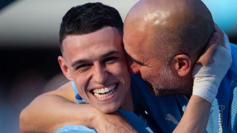 Phil Foden embraces Pep Guardiola after Manchester City's 2023-24 Premier League title win