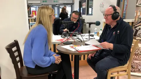 Everyone Active Hfm broadcasting from the leisure centre live with Rebecca Adlington, around a small table and chairs