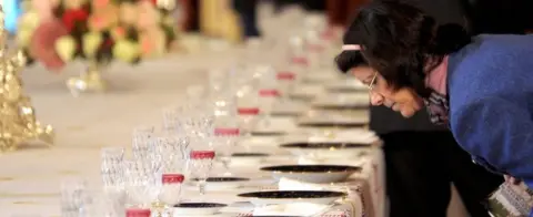Getty Images File pic of a visitor inspecting a dinner table at the presidential palace in 2008