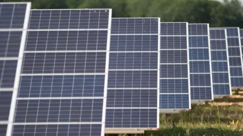 A set of solar panels in a field.