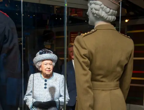National Army Museum The Queen looking at her former uniform during museum visit in 2017