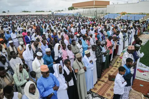 AFP Somali Muslims take part in Eid al-Fitr prayer which marks the end of the holy month of Ramadan at the football pitch of the Jamacadaha stadium in Mogadishu, on June 15, 2018