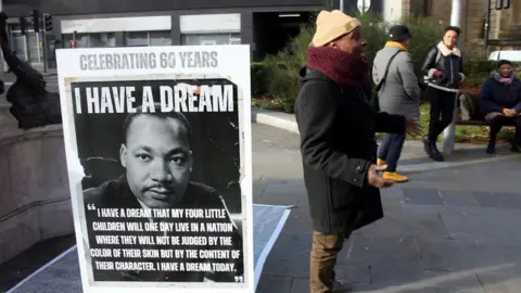 Race for Power Julz standing next to a Martin Luther King plinth