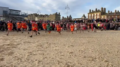 Matt Stebbings Swimmers in fancy dress taking part in a Christmas Day swim in Lowestoft