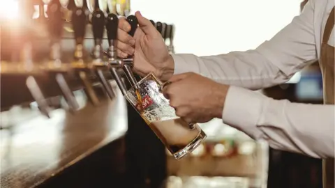 Getty/PixelsEffect bartender pulls a pint