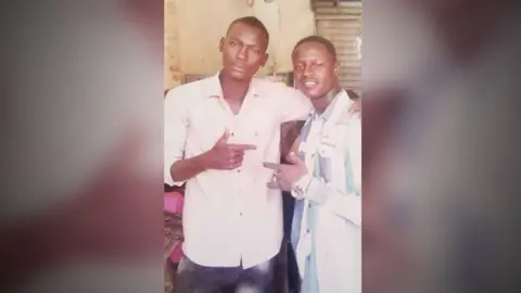 Abdalaziz Osman Mustafa (on the left) with a family member