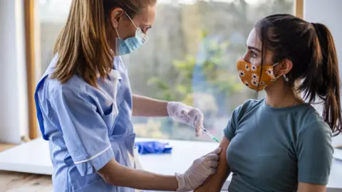Getty Images woman receives covid jab