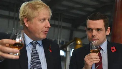 Getty Images Boris Johnson tastes whisky with Douglas Ross during a general election campaign visit in November 2019