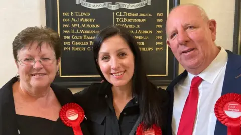 Beverley (left) and David Hopkins (right) with daughter Nicola Matthews (centre)