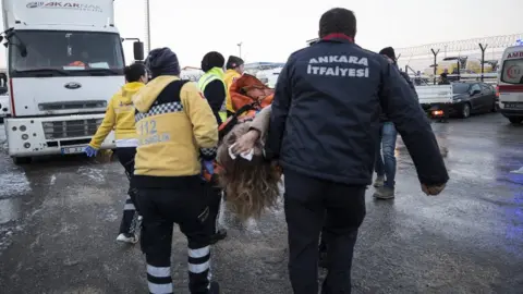 Anadolu Agency Rescue workers evacuate injured passengers after crash