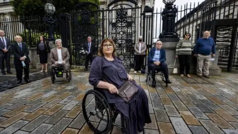 Liam McBurney/PA Jennifer McNern (centre) outside Belfast High Court On Monday