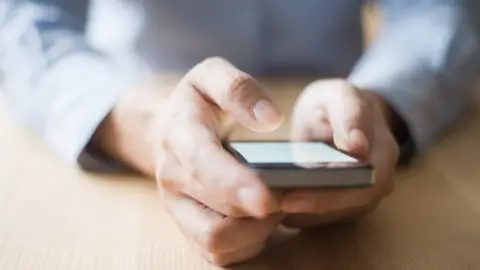 Getty Images Person holding phone