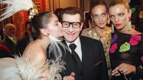 Getty Images Yves Saint Laurent pictured with models in January 2000