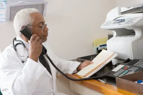 Getty Images Doctor and fax machine