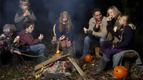 Getty Images family around a campfire