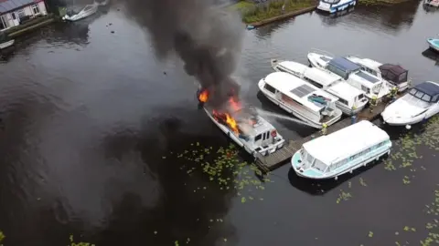 Steve Moore The fire on a boat at Hoveton, Norfolk