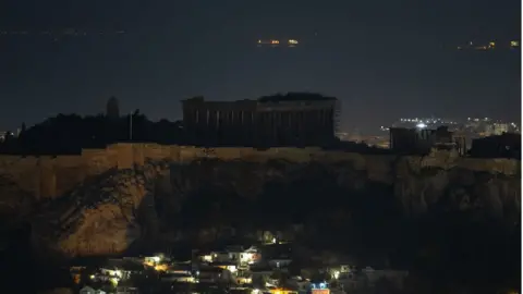 Getty Images The ancient Parthenon temple is pictured atop the Acropolis Hill during Earth Hour in Athens, Greece