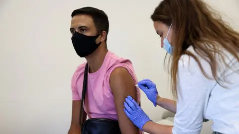 Getty Images Woman receives a monkeypox vaccine