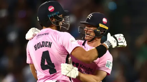 Middlesex players Max Holden and Jack Davies celebrate their win over Surrey