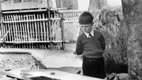 Richard Woodman-Bailey Richard Woodman-Bailey in the 1950s looking at his father's drawing board at Stonehenge