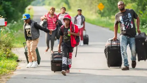 AFP Refugees cross at Roxham Road in Quebec