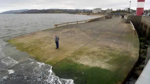 Pacemaker A man stands on Buncrana pier, where the family's car entered the water