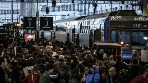 AFP Travellers walk on a platform at the Gare de Lyon railway station in Paris on December 20, 2019