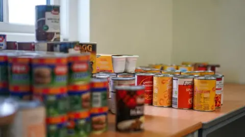 Getty Images A table full of canned foods at a food bank