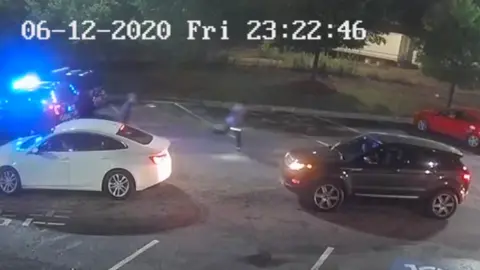 The Georgia Bureau of Investigation CCTV footage shows Mr Rolfe and Mr Brooks running, both holding Tasers