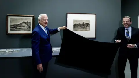 EPA Two men remove a black curtain from the previously unseen Van Gogh sketch