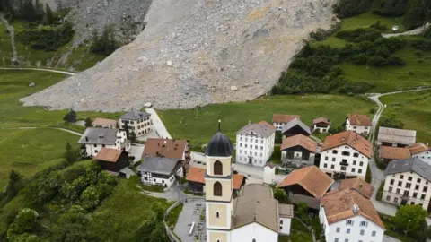 MICHAEL BUHOLZER/EPA-EFE/REX/Shutterstock The overnight rockfall just missed the village, coming to a halt close to the local school