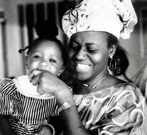 Sunmi Smart-Cole A photo by Sunmi Smart-Cole entitled: "First Lady Maryam Babangida, and daughter, Halima, on her first birthday" - 1991