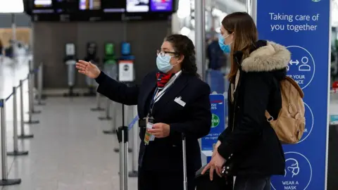 Reuters An airline employee helping someone at Heathrow Airport