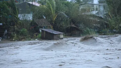 CHARISM SAYAT/Getty Images A general view shows a swollen river due to heavy rains brought by Super Typhoon Goni in Legazpi City, Philippines' Abay province on November 1, 2020.