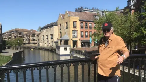 Peter De La Haye Woody stood in front of a bridge in Cambridge