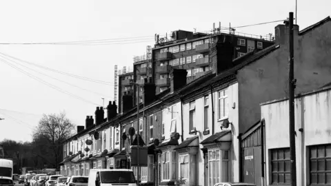 Luca Onofrio Row of terraced houses and satellite dishes