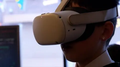Winnie Ngai/BBC Young person with VR headset on