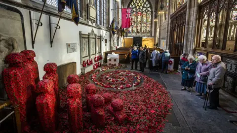 PA People look at an installation titled Coming Home by artist Martin Waters at Hull Minster.