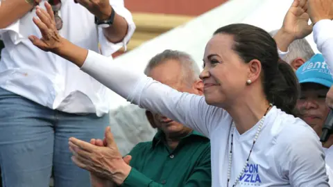 Getty Images August 11, 2023, Maracaibo, Venezuela: Maria Corina Machado of the party Vente Venezuela, greets her supporters after her speech at a rally for the presidential candidacy in the upcoming elections in Venezuela.