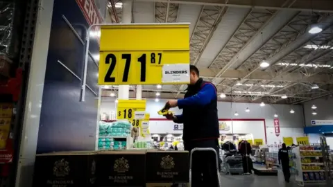 EPA A supermarket employee changes products' price tags due to inflation, in Buenos Aires, Argentina, 14 August 2019